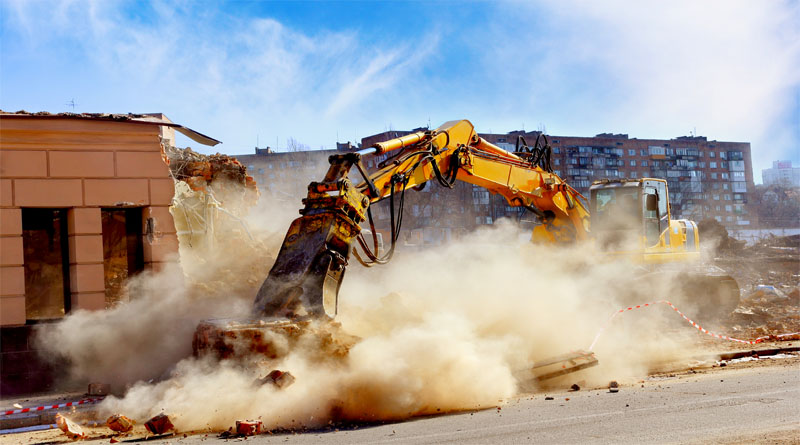 Crane Demoloshing building creating dust