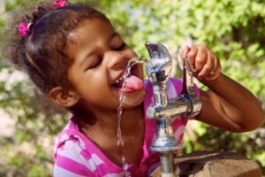Child drinking from fountain
