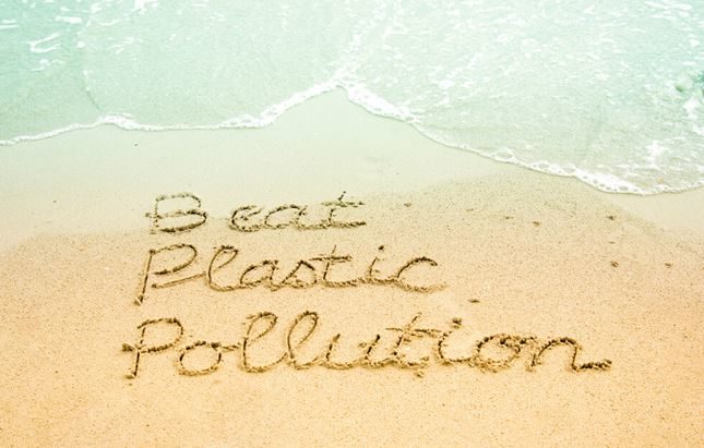 Beat Plastic Pollution written on beach