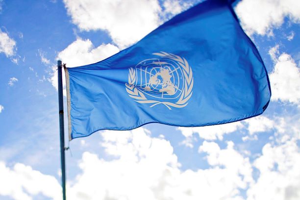 UN Flag blue sky BG